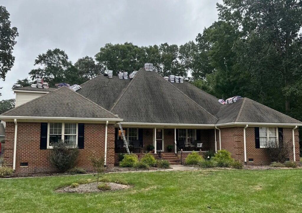 Roofing contractor fixing shingles on residential home in Happy Valley
