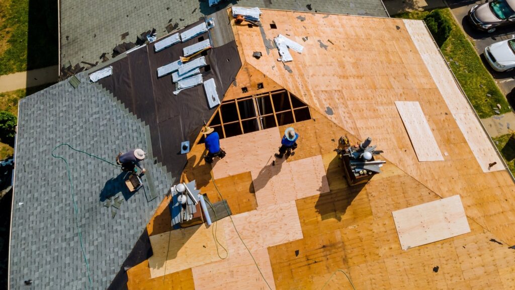 Alpine Exteriors crew installing asphalt shingles