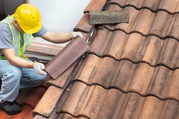 Roofer repairing shingles on Clackamas, OR home