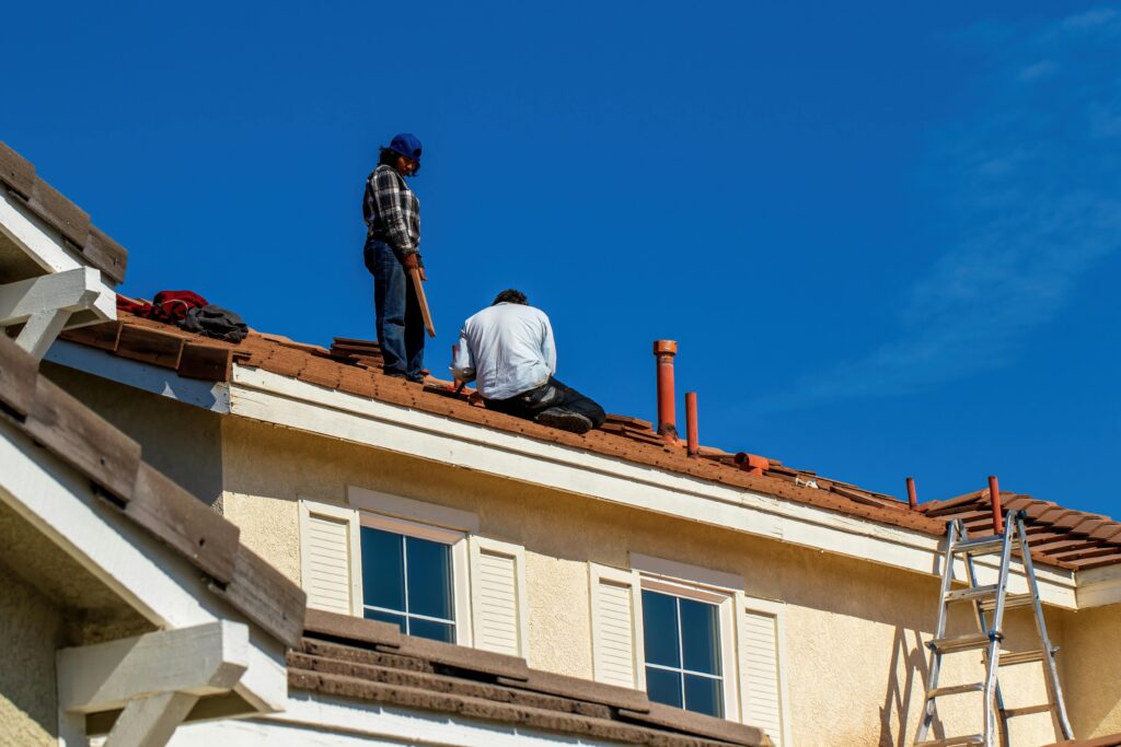 Roofer fixing damaged shingles on Beaverton home roof