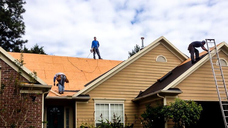 Professional roofer repairing damaged roof in Hood River, OR